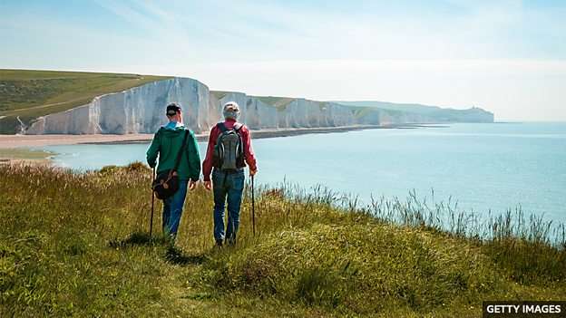 World's longest coastal path opened by King Charles